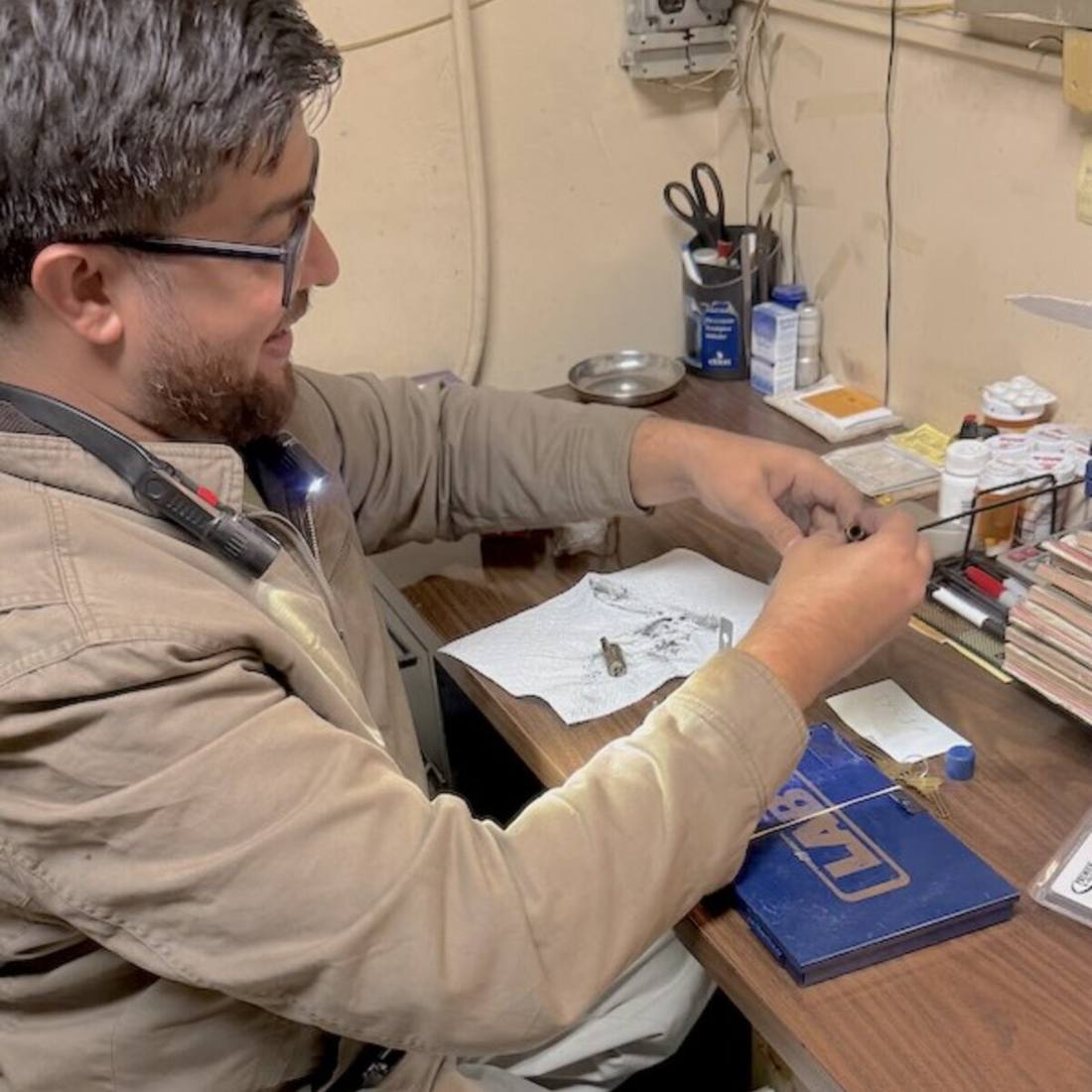 Ali, owner of Aura Locksmith, hand-cutting a key at the Brooklyn workbench