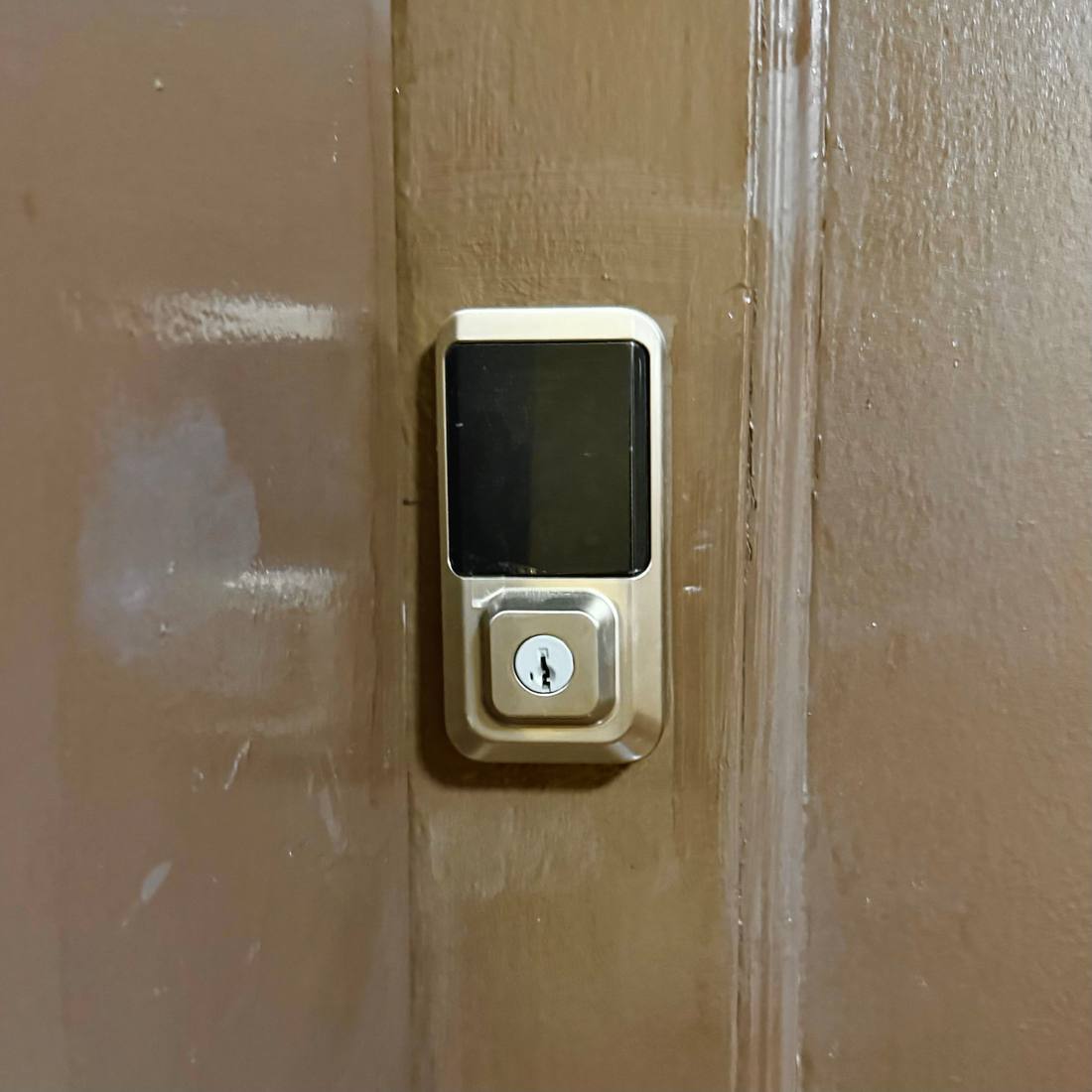 Keypad smart deadbolt with backup key cylinder installed on a Brooklyn apartment door by Aura Locksmith