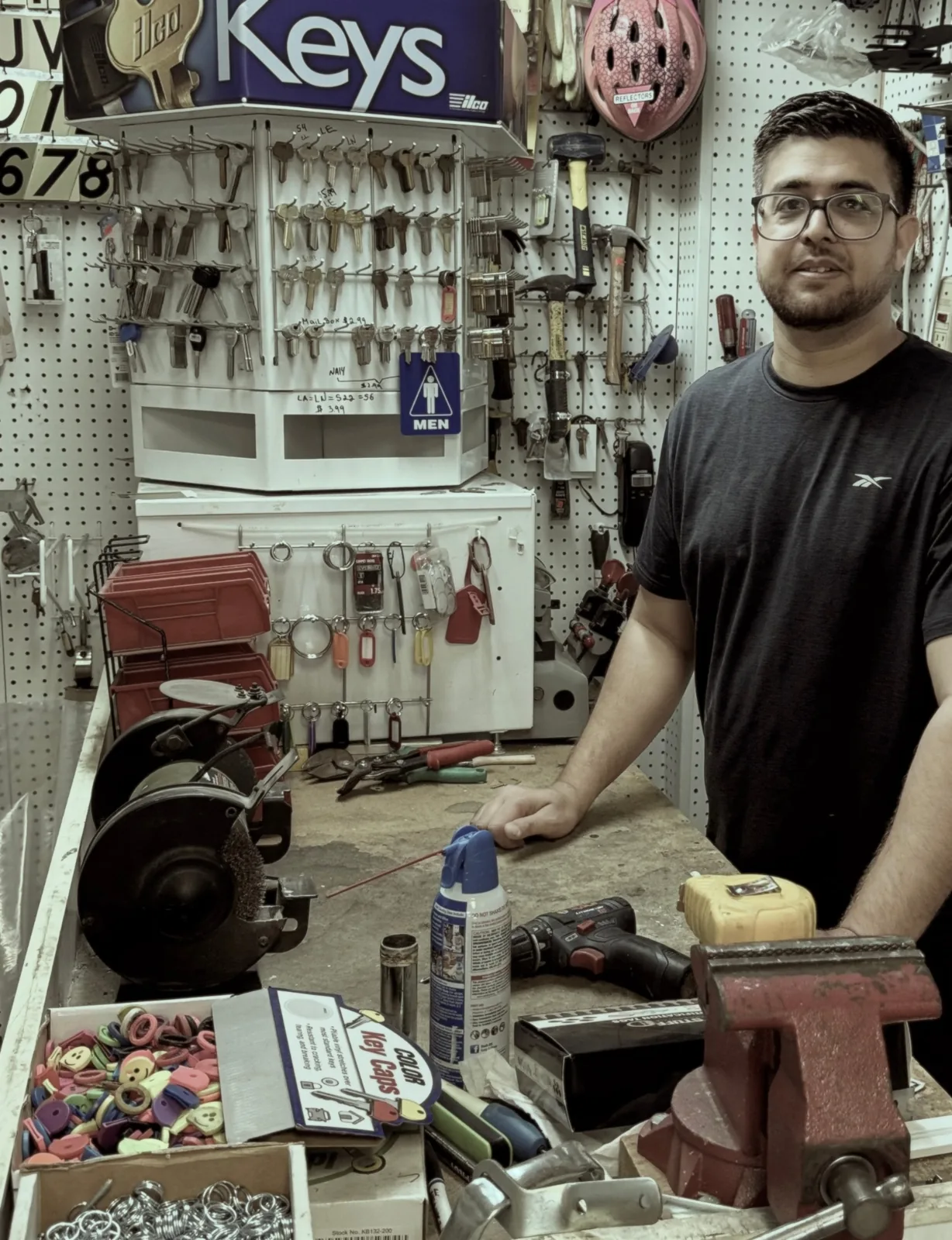 Ali, owner of Aura Locksmith, behind the key counter inside Quentin Hardware & General Supply on 3203 Quentin Rd, Brooklyn.